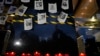 FILE - Photos of slain journalists are displayed on a wall during a vigil to protest the murder of journalist Fredid Roman, outside Mexico's Attorney General's office in Mexico City, Aug. 24, 2022.