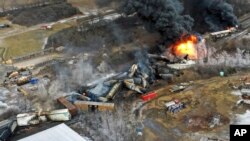 FILE - This photo taken with a drone shows portions of a Norfolk and Southern freight train that derailed Friday night in East Palestine, Ohio are still on fire at mid-day Saturday, Feb. 4, 2023.