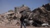 A man walks past rubble at the site of a collapsed building, in the aftermath of a deadly earthquake in Kahramanmaras, Turkey, Feb. 12, 2023. 