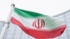 Bendera Iran berkibar di depan gedung Pusat Internasional yang juga merupakan markas Badan Tenaga Atom Internasional (IAEA), di Wina, Austria, pada 24 Mei 2021. (Foto: AP/Florian Schroetter)