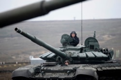 FILE - Russian troops take part in drills at the Kadamovskiy firing range in Russia's southern Rostov region, near the country's border with Ukraine, Dec. 14, 2021.