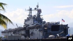 FILE - The amphibious assault ship USS Peleliu is seen docked following joint exercises at the Alava pier, off Subic Bay Freeport zone, northwestern Philippines, Oct. 13, 2014, as part of the Visiting Forces Agreement.