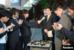 Japan's Prime Minister Shinzo Abe speaks to reporters at his office in this photo taken by Kyodo, in Tokyo, Japan April 24, 2017, after speaking with U.S. President Donald Trump on the phone.