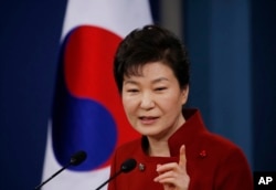 FILE - South Korean President Park Geun-hye answers to a reporter's question during her news conference at the Presidential Blue House in Seoul, South Korea, Wednesday, Jan. 13, 2016.