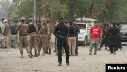 FILE - A policeman stands guard at the scene of a bomb attack in Peshawar, Pakistan, Feb. 15, 2017.
