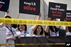 FILE - Activists protest against fossil fuels at the COP28 U.N. Climate Summit on Dec. 5, 2023, in Dubai, United Arab Emirates.