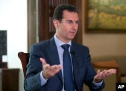 Syrian President Bashar Assad speaks to The Associated Press at the presidential palace in Damascus, Syria, Sept. 21, 2016..