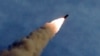 A missile is fired during the test of a multiple rocket launcher in this undated photo released Aug. 25, 2019, by North Korea's Korean Central News Agency.