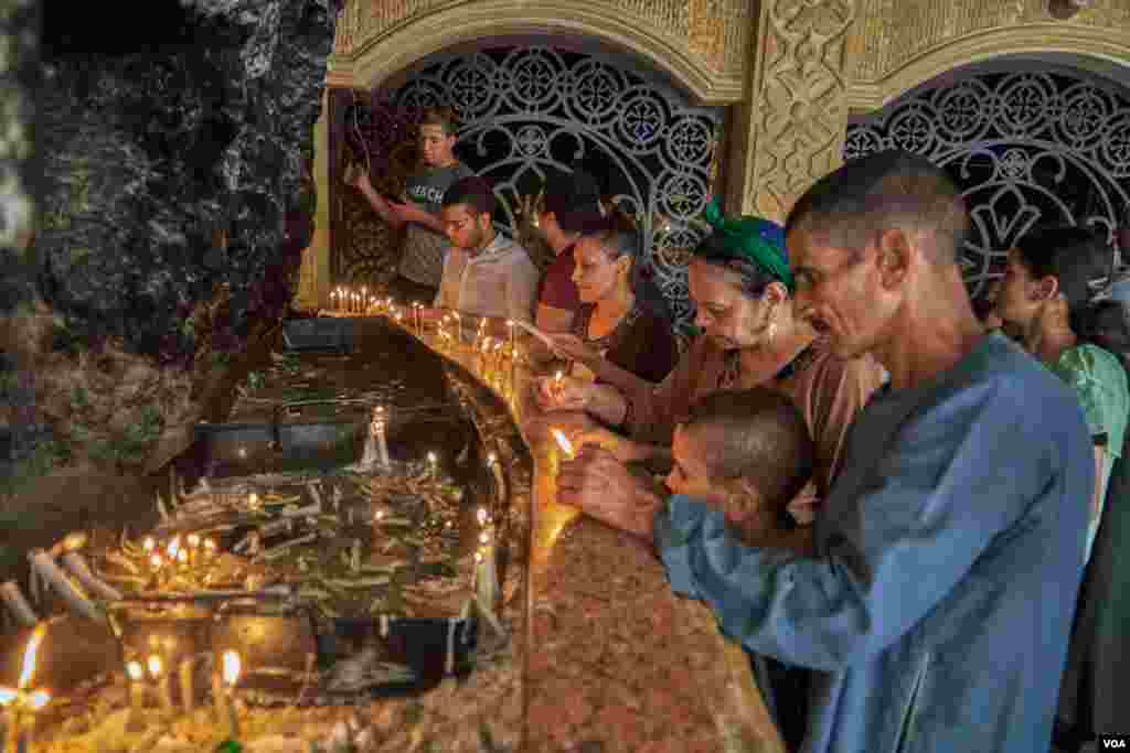 Upon arriving at the monastery, the pilgrims light candles and pray. Sunday, August 18, 2019.