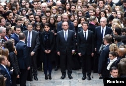 From left, French Minister for Higher Education and Research Thierry Mandon, French Education Minister Najat Vallaud-Belkacem, French President Francois Hollande and French Prime Minister Manuel Valls observe a minute of silence at the Sorbonne University in Paris, Nov. 16, 2015.