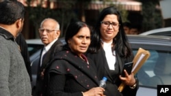 Asha Devi, center, mother of the victim of the fatal 2012 gang rape on a moving bus, leaves the Supreme Court in New Delhi, India, Dec. 18, 2019. 