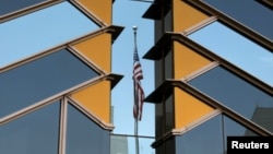FILE - The U.S. flag is reflected on the windows of the U.S. Embassy in Kabul, Afghanistan, July 30, 2021.