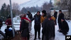 FILE - Relatives and friends of Syrian refugee Naziha Al-Ahmad bury her in a cemetery after she died during an earthquake, in Elbistan, southeastern, Turkey, Feb. 10, 2023. 