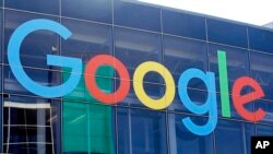 FILE - A sign is shown on a Google building at their campus in Mountain View, Calif., Sept. 24, 2019.