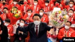 윤석열 한국 대통령 당선인이 10일 새벽 서울 여의도 국회도서관에 마련된 '국민의힘 제 20대 대통령선거 개표상황실'에서 당 관계자와 지지자들의 축하를 받고 있다.