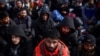 Foreign nationals fleeing Russia's invasion of Ukraine wait at the Shehyni border crossing to enter Poland, near Mostyska, Ukraine, March 1, 2022. 