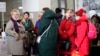 A group of women who fled Russia's invasion of Ukraine wait inside a train station in Zahony, Hungary, March 7, 2022.