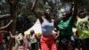 A group of women's right campaigner take part in celebrations for International Women's Day with residents of informal settlement in Nairobi on March 8, 2022.