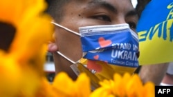 Taiwanese march on the streets protesting the war in Ukraine during a rally in Taipei on March 13, 2022. 