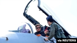 Pakistan's Prime Minister Imran Khan sits in the cockpit of the Chinese J-10 C combat aircraft as he is briefed during the induction ceremony at the Pakistan Air Force (PAF) base in Kamra, Pakistan, March 11, 2022.