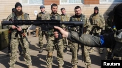 Members of the Ukrainian Territorial Defence Forces take part in exercises, amid Russia's invasion of Ukraine, in Kyiv, Ukraine, March 24, 2022.