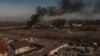Asap mengepul dari kontainer yang terbakar setelah penembakan di Vasylkiv, barat daya Kyiv, Ukraina, Sabtu, 12 Maret 2022. (Foto: AP/Felipe Dana)