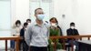 This picture taken and released by the Vietnam News Agency shows Vietnamese activist Le Van Dung in a courtroom during his trial in Hanoi, March 23, 2022, as he was sentenced to 5 year in jail. 