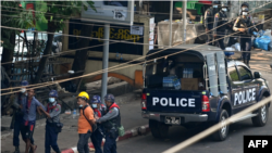 Police arrest people in Yangon, Myanmar, on February 27, 2021. At least five journalists remain in detention over their coverage of anti-coup protests. 