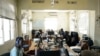 FILE - "Eye Radio" journalists work at their desks in Juba, South Sudan, March 2, 2019.