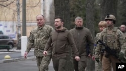 President Volodymyr Zelenskyy walks to a hospital to visit patients and staff, March 13, 2022 in Kyiv. (Ukrainian Presidential Press Office via AP)