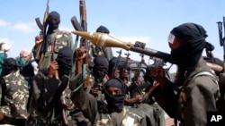 FILE - Armed al-Shabab fighters ride on pickup trucks as they prepare to travel into Mogadishu, Somalia, Dec. 8, 2008. Sources report that a March 2024 military operation in Lower Shabelle region has killed nearly 40 al-Shabab militants.