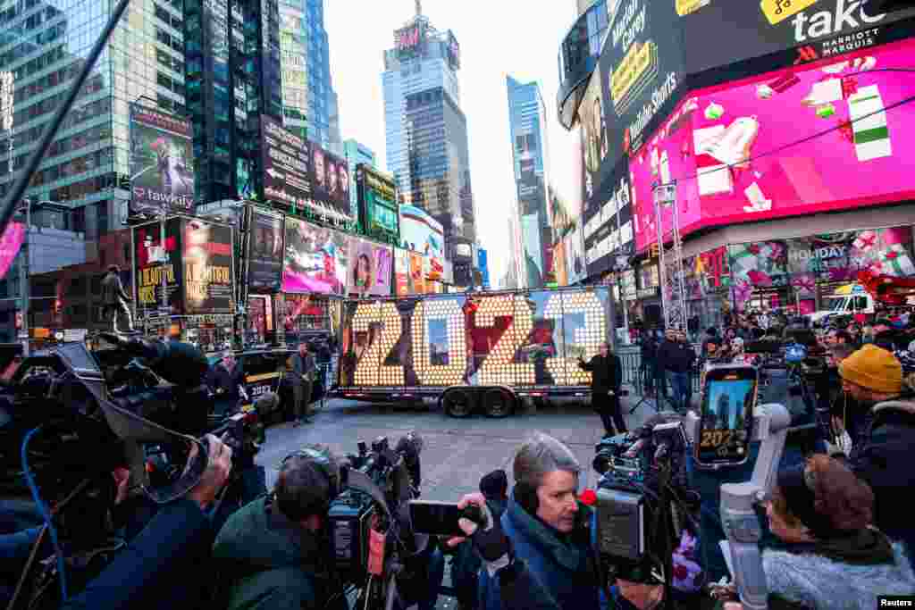 People take a look at the giant, seven-foot-tall numerals for &quot;2023&quot;, as it arrives for the December 31 Times New Year&#39;s Eve celebrations, at Times Square in New York City.