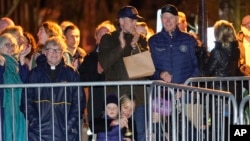President Joe Biden stands with his son Hunter Biden and other family members during the annual Christmas Tree Lighting ceremony in Nantucket, Mass., Friday, Nov. 25, 2022.