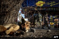 Ukrainian soldiers buy food in Kostyantynivka, eastern Ukraine on Dec. 1, 2022, amid the Russian invasion of Ukraine.
