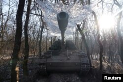 A German howitzer Panzerhaubitze 2000 is disguised by the Ukrainian army of the 43rd Heavy Artillery Brigade, as Russia's attack on Ukraine continues, near Soledar, Ukraine, Jan. 11, 2023.