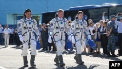 NASA astronaut Frank Rubio, left, walks with Russian cosmonauts Sergey Prokopyev, center, and Dmitri Petelin, right, prior to going into space on Sept. 21, 2022.