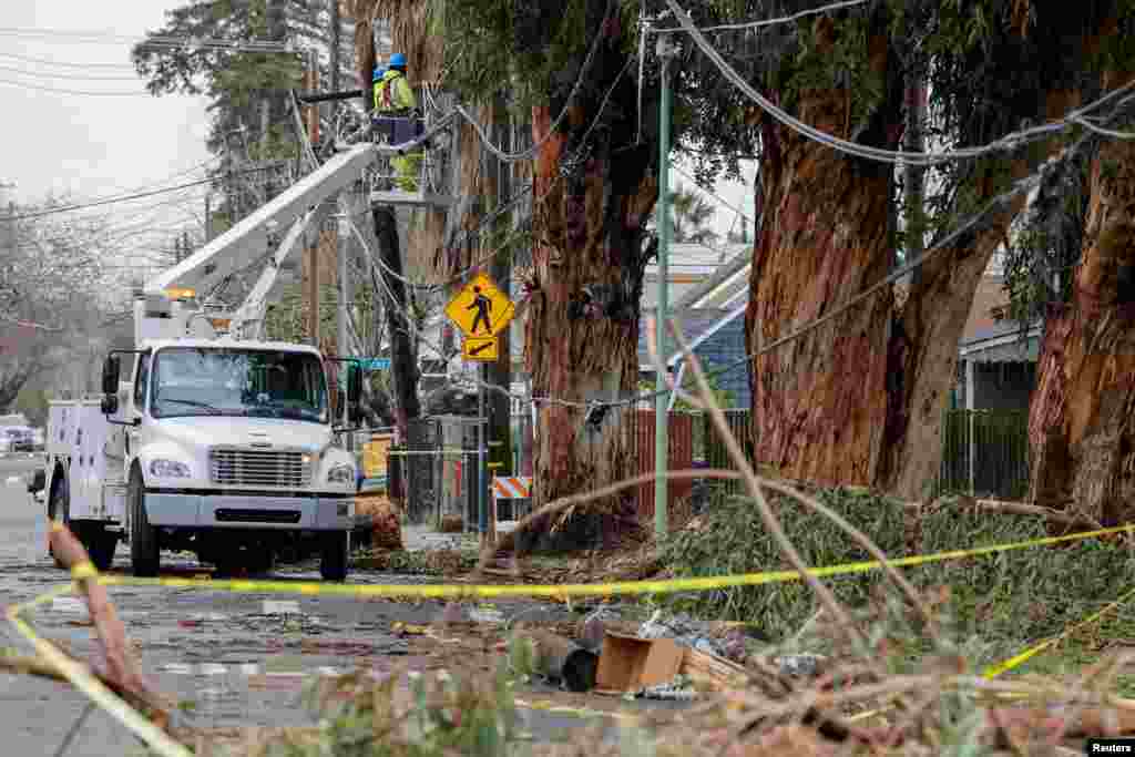 A Sacramento Municipal Utility District crew is repairing downed power lines following storms in Sacramento, California, Jan. 9, 2023.