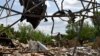 Sejumlah orang tampak membersihkan area gedung yang hancur akibat serangan rudal di Sloviansk, Ukraina, pada 1 Juni 2022. (Foto: AP/Andriy Andriyenko)