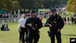 British police officers patrol along the Long Walk towards Cambridge gate outside Windsor Castle in Windsor, England, Sept. 18, 2022. 