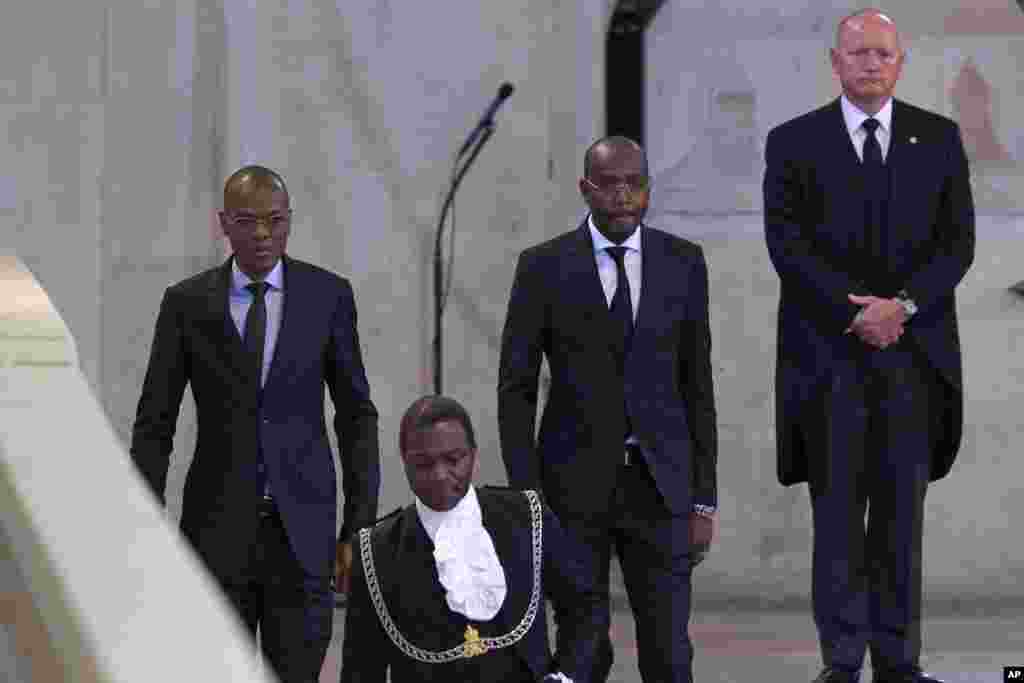 Chad's Minister of Petroleum and Energy, Djerassem Le Bemadjiel, left, arrives to pay his respects to Queen Elizabeth II inside Westminster Hall in London, Sept. 18, 2022.