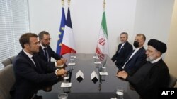 French President Emmanuel Macron (L) holds a bilateral meeting with Iranian President Ebrahim Raisi on the sidelines of the 77th United Nations General Assembly at UN headquarters in New York City, Sept. 20, 2022.