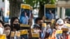 Sekelompok aktivis plakat bergambar foto Toru Kubota, warga negara Jepang yang ditahan di Myanmar, dalam aksi unjuk rasa di depan Kementerian Luar Negeri di Tokyo, 31 Juli 2022. (Philip FONG / AFP)
