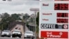 FILE - Motorists drive past a fuel price display in Sydney, March 29, 2022. With inflation increasing in Australia the government is expected to reduce its 44.2 Australian cents (33.1 U.S. cents) a liter ($1.25 a gallon) tax on gasoline. 
