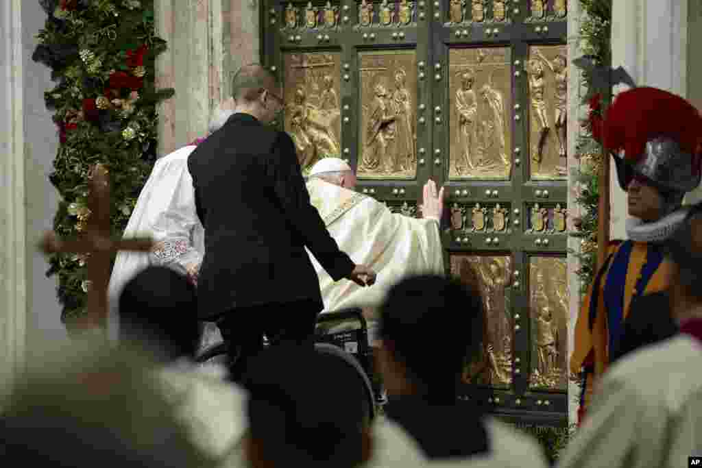 Pope Francis opens the Holy Door to mark the opening of the 2025 Catholic Holy Year, or Jubilee, in St. Peter's Basilica at the Vatican.