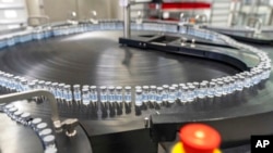 This August 2022 photo provided by Pfizer shows vials of the company's updated COVID-19 vaccine during production in Kalamazoo, Mich. 
