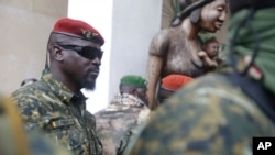 FILE - Guinea's Junta President Col. Mamady Doumbouya leaves a meeting with an ECOWAS delegation in Conakry, Guinea, Sept. 10, 2021.