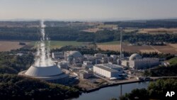 FILE - Water vapor rises from the cooling tower of nuclear power plant of Neckarwestheim in Neckarwestheim, Germany, on Aug. 22, 2022.