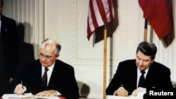 FILE - U.S. President Ronald Reagan (R) and Soviet President Mikhail Gorbachev sign the Intermediate-Range Nuclear Forces (INF) treaty in the White House December 8 1987.