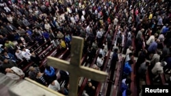 FILE - Worshipers pray during mass at Liuhe Catholic Church in Liuhe village on the outskirts of Qingxu county, northern China's Shanxi province, Sept. 11, 2011. China's Christian community is estimated at between 60 and 100 million believers.