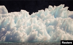 A large iceberg melts into jagged edges as it floats in Eriks Fjord near the town of Narsarsuaq in southern Greenland, July 26, 2009.